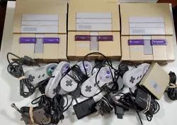 The lot includes 3 SNES consoles. All three have various audio/video output issues. Two currently power on. The silent...