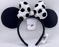 Minnie Mouse Ears headband featuring a white bow with black velvet like polka dots, similar to the material of the ears...