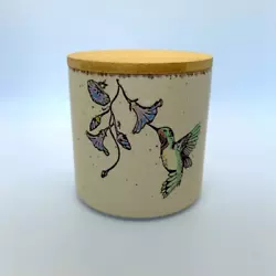 The canister is a soft, nostalgic design of hummingbirds with flowers. Stoneware canister with secure fitting wood lid....
