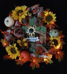 With Sun flowers, flowers, pine cones, gourds, etc. Assorted sunflowers, pine cones, flowers, gourds, leaves, ribbons,...