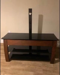 Sleek hardwood legs. Removable black glass shelves.