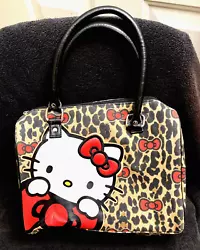 Super cute Hello Kitty purse has red lining with one zipper pocket on the inside. One small knick on the front (see...