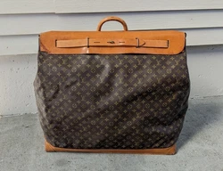 Louis Vuitton twice on the outer flap all of the brass rivets are marked Louis Vuitton and it is also Mark Louis...