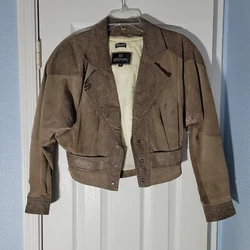 The outer shell is made of high-quality leather with a solid pattern and a snap closure. It features a short length,...