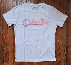 White super soft cotton shirt has script logo graphic silkscreened in pink on front. Plain back.