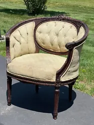 Antique French Louis XVI Bergere Chair c. 1900 having deeply tufted ivory colored silk upholstery and a nicely carved...