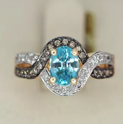 0.36 CTW of clear and champagne diamonds. 8x6 mm Blue Topaz. Size 7 but can be resized by any reputable jeweler.