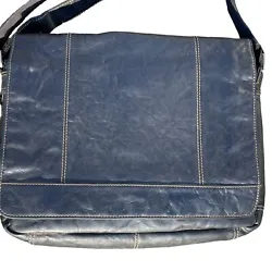 The bag has a full-length flap with zippered closure beneath for added security. The adjustable leather shoulder strap...