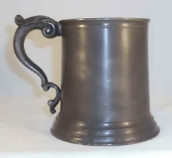 The tankard is equipped with an applied handle having leave decorated with a rolled end thumb piece. The mug is marked...