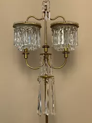 Approximately 65” high 17” wide 2 lights. Exquisite crystal floor lamp candelabra. All prisms accounted for. Wear...