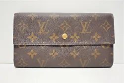 Portefeuille INTERNATIONAL Louis Vuitton, en toile monogram. Composition : toile enduite. Coloris : marron. Largeur : 2...