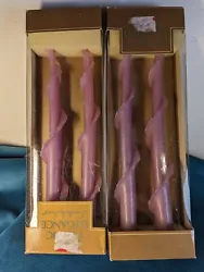 Two boxes of purple Lennox beeswax candles. While these candles have been previously displayed, they are all unlit. ...