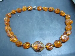 amber necklace vintage I think the main stone is hand blown glass the mechanism that holds the back together tests...