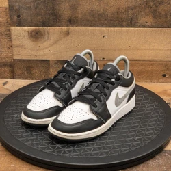 The product you are purchasing is a pair of NIKE AIR JORDAN RETRO 1 LOW kids shoes in a Size 4.5Y. They have a classic...