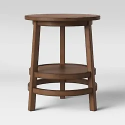 •Brown wooden accent table includes an open shelf for additional display space •Round silhouette with angled legs...