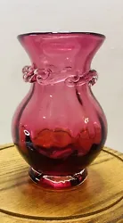 Up for sale is a beautiful cranberry glass vase with applied clear ribbon. This vintage vase is hand blown and features...
