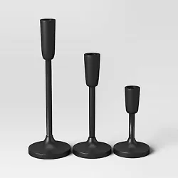 •Set of candleholders in black •Includes 3 identical taper candleholders of varying heights •Made of metal...