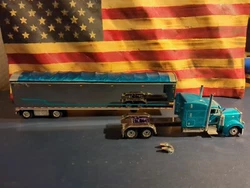 This DCP 1/64 Scale Peterbilt With Sleeper And Utility 4000D-X Trailer is a must-have for any collector or fan of semi...
