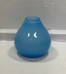 This unique contemporary vase is made of high gloss light blue thick glass material. Its shape resembles a small...