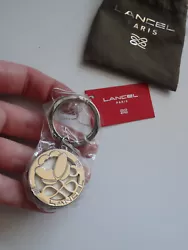 Breloque Porte-Clés Fleur argenté Cuir blanc Lancel Paris.