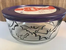 This is a 4-cup Pyrex bowl. It has black bats and purple plastic lid with label. No sticker on bottom. It is in...