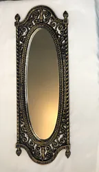 Enhance the aesthetic of your living space with this vintage 1973 Homco oval wall mirror. -Crafted with black and gold...