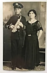Holding a Small Saxophone. Young Man Wearing a Band Uniform.