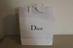 Grey DIOR logo on both sides. Pebble grain textured thick cardboard paper bag with rope carry handles.