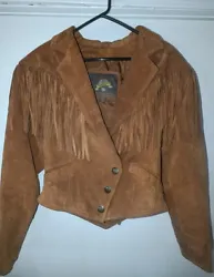So cute! Vintage and in great condition with very few signs of wear. This side snap Wilsons short fringe jacket would...