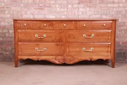 An exceptional French Provincial style seven-drawer dresser or credenza. By Ethan Allen. Newly refinished. Excellent...