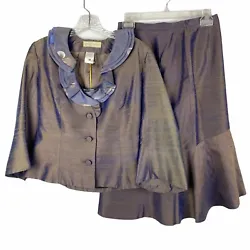 This is in near new condition. Blue iridescent silk jacket, camisole and skirt. Fully lined. Converts to a size 6 US....