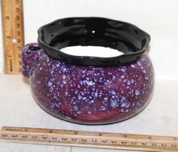 This is a self watering pot just fill the base with water. This is an excellent pot for standard size African violets...