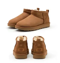 Leather heel label with embossed UGG logo. Color: Chestnut. Style: Classic ultra mini ankle boots.