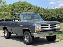 Offered here is a 1988 Dodge Ram W100. This example is finished in gray over a red leather interior.