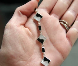 Genuine onyx and mother of pearl. Set in sterling silver.