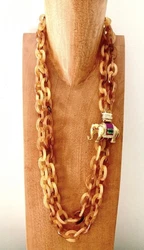 Gorgeous statement necklace from JCrew in resin amber tortoise links. Double strands connected to large gold elephant...