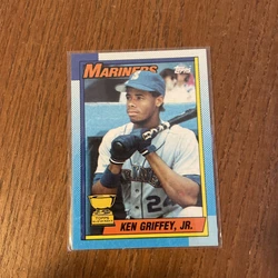 This 1990 Topps Tiffany trading card features baseball player Ken Griffey Jr. in his rookie season with the Seattle...