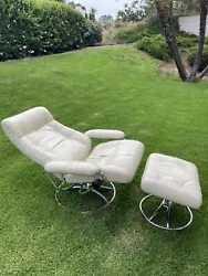 Designed and made in Norway by the brand Ekornes, this chair and ottoman set comes in a solid bone white pattern, with...