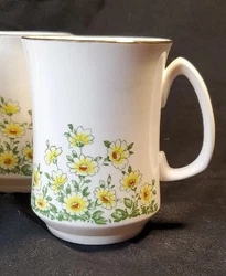 Add a touch of vintage charm to your collection with this three-piece floral cup and saucer set.  The delicate bone...