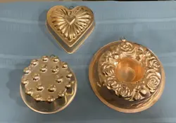 A heart, a ring with roses and a round shaped mold. The copper tone has faded in different degrees.