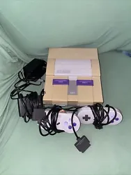 super nintendo console + 2 controllers + Cords Bundle Tested/ Working. Works great it just has a hole on it and some....