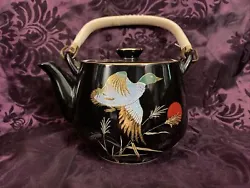 Black China Tea Kettle. Has a chip on the top but piece is still with it, I would consider this for home decor but...