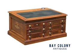 The cabinet also functions as a writing desk with a slant lid writing surface and the original inset inkwell with a...