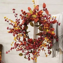This is a new candle ring wreath of artificial berries in red, orange, and yellow fall colors.