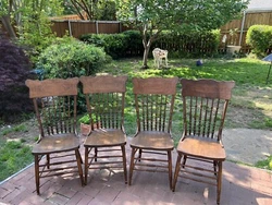 Beautiful Oak pressed back chairs x 4, as is condition. All of the chairs have a few chew marks on the bottom rungs,...