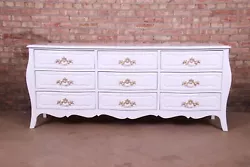 A gorgeous French Provincial Louis XV style triple dresser or credenza. White lacquered walnut, with original brass...