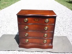 This classic chest of drawers has a traditional style with serpentine front and 4 dovetailed drawers with brass pulls...