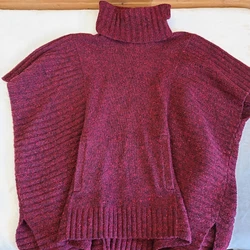 The turtleneck and short flutter sleeves add a touch of elegance to the solid red color. Knit from a combination of...