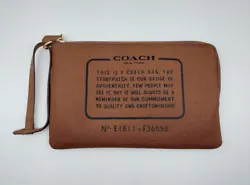 This pretty leather storypatch wristlet/clutch from Coach is in very good used condition with minor preowned wear.