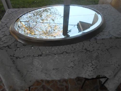 Oval shaped, beveled mirror.